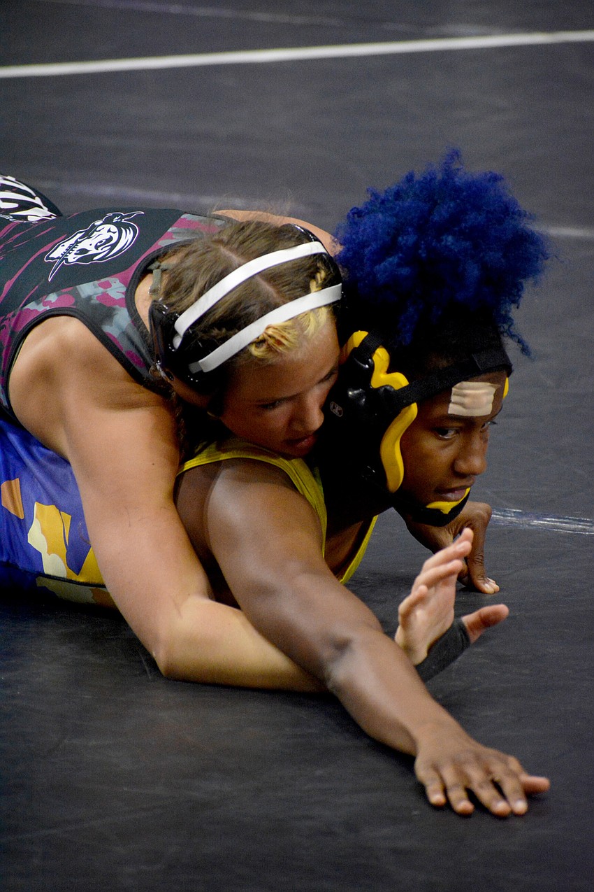 Braden River sophomore girls wrestler Giovanna Coppola holds down Osceola's Kellianna Mack. Coppola would lose the match.
