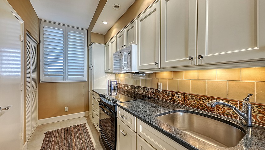 The kitchen offers an adjacent dining area alongside the living space.