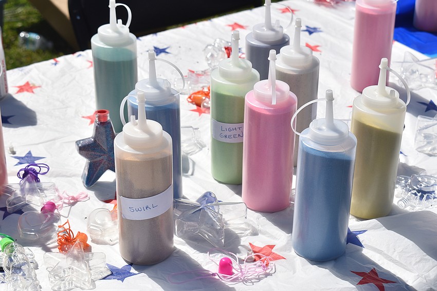The town table had an activity with colored sand for the kids.