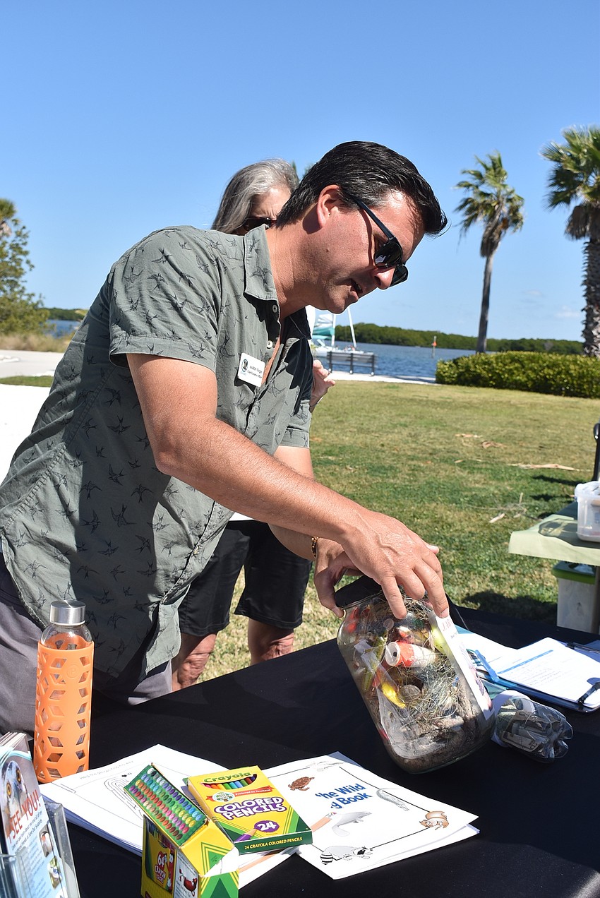 Save Our Seabirds CEO Aaron Virgin shows what rescued birds accumulate in the Jar of Death.