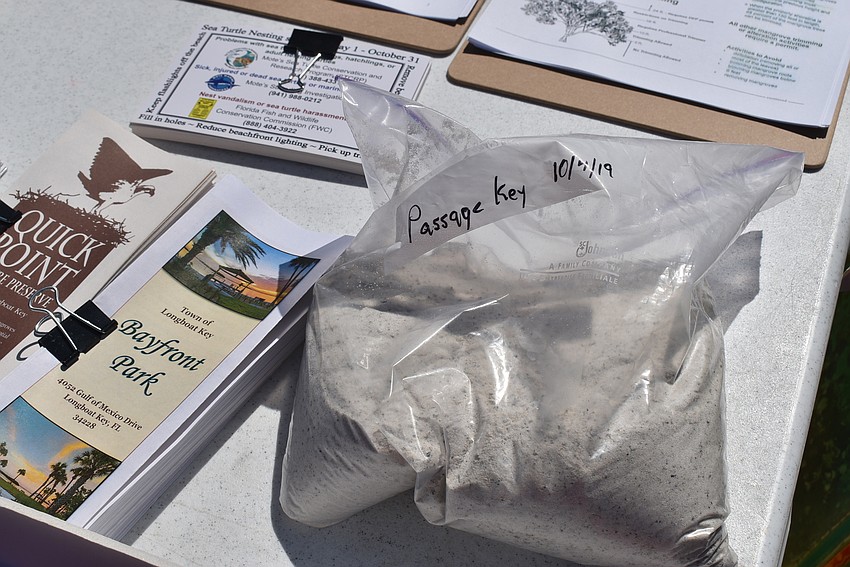 At the Public Works table, a sample of renourishment sand was on display.