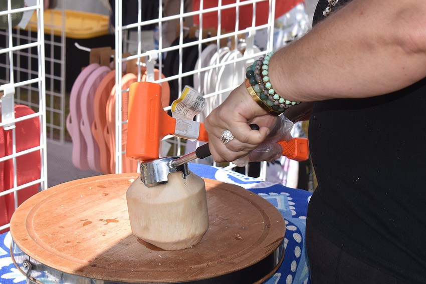 Amanda Champ cracks open a coconut.