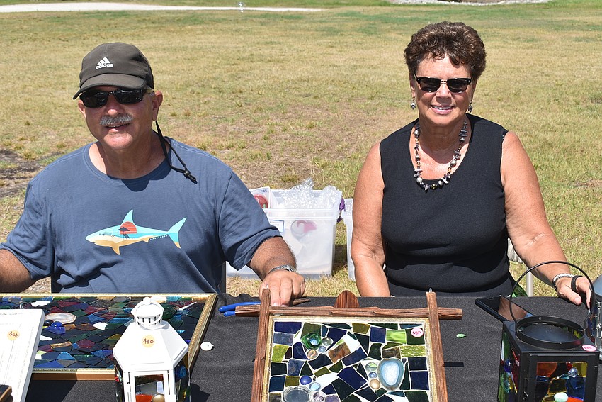 Paul and Danene Jaffe set up a table of mosaic art.