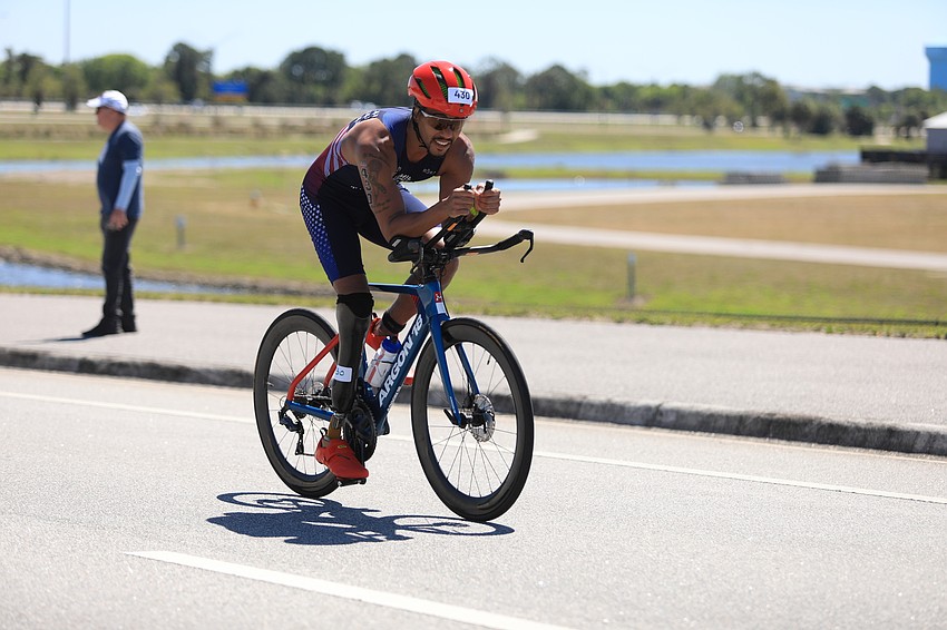 Robert Rodriguez bikes through the park.