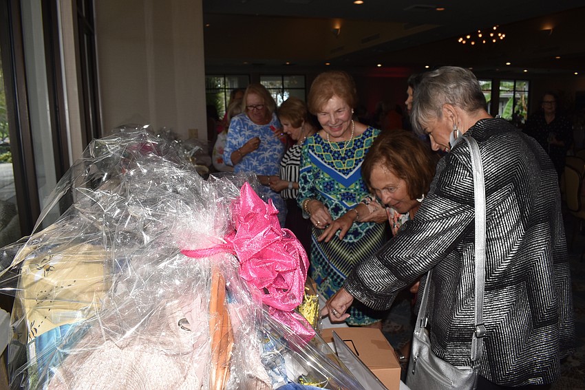 Ronda Montminy, Fran Dragotta and Toni Ann Vitelli browse the raffle baskets.