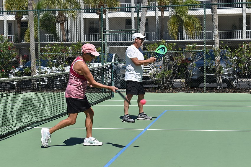 Darlene Sedlock hits a point while playing with Mac Pratt.