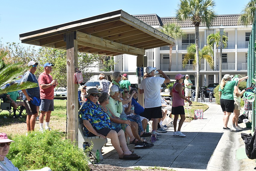 About 50 players and spectators sat on the sidelines to watch current games.