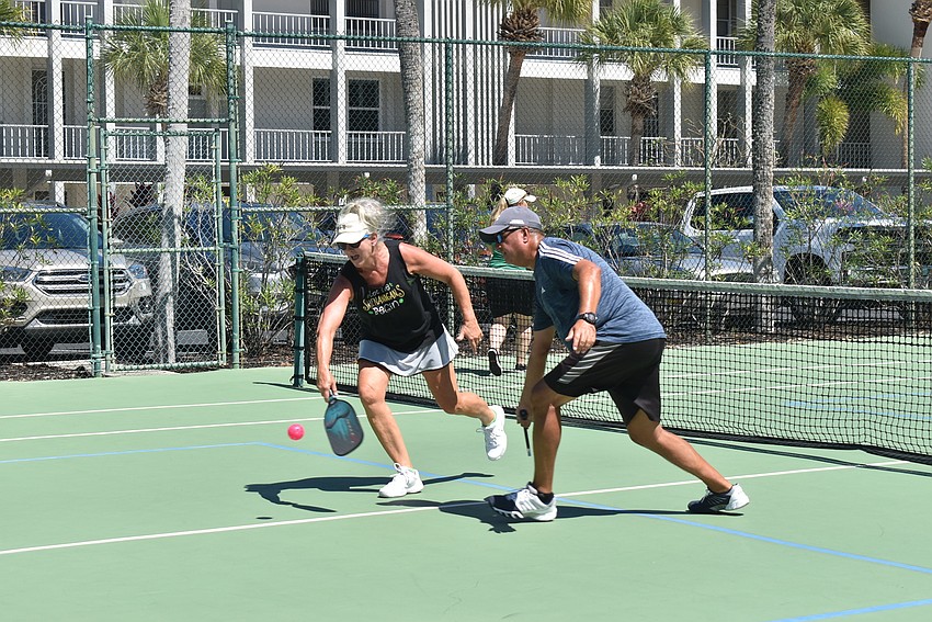 Andy Tanchel and Mary Dice go for the ball.