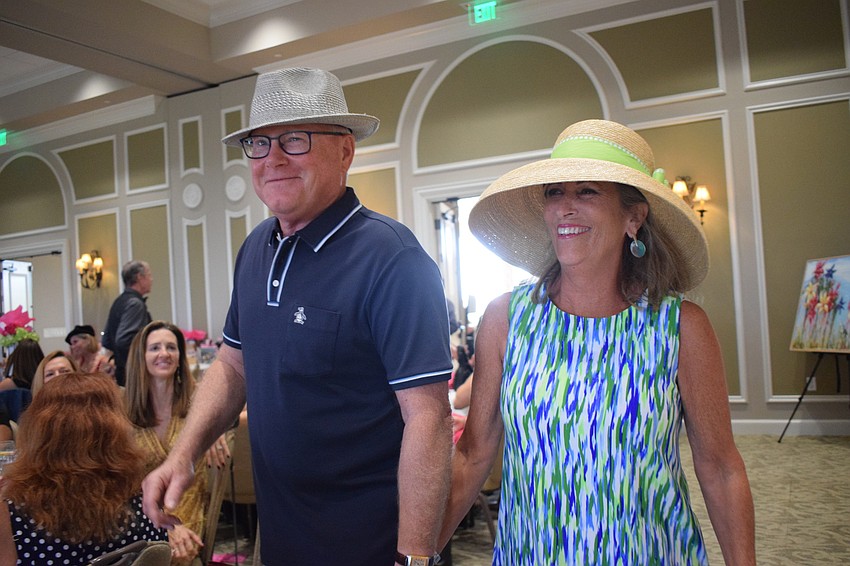 Lakewood Ranch's Rick and Jill Wellinger have fun modeling clothes during the fashion part of the event.