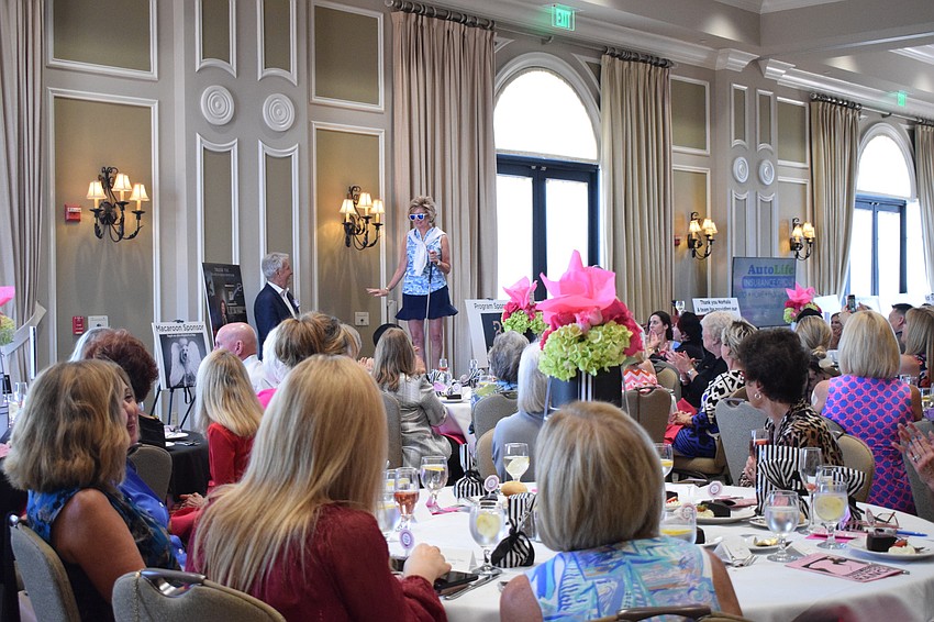 Lakewood Ranch's Susan Jenkins stands on top of a platform for everyone to see her golf outfit.