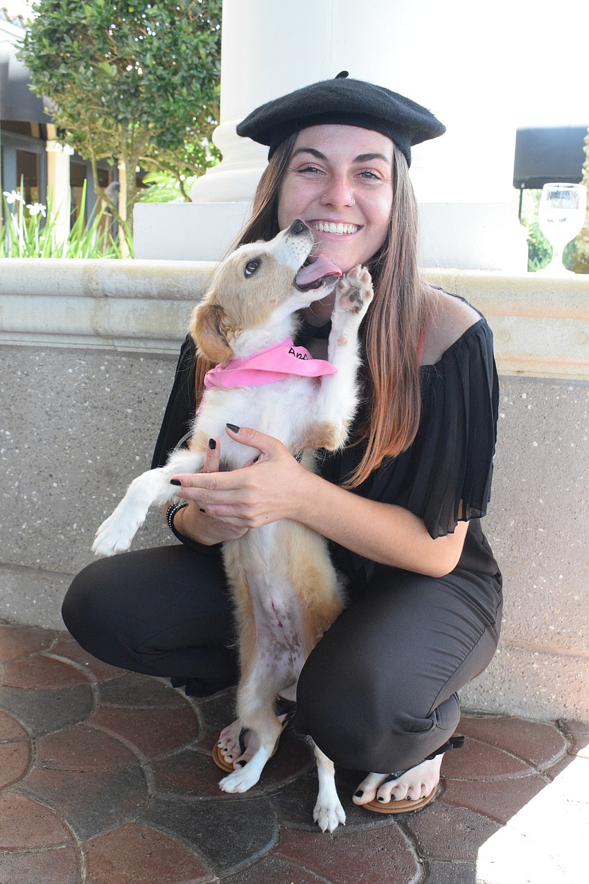Mora Jordan, a kennel technician for the Humane Society at Lakewood Ranch, gets some love from Lady, a 4-month-old puppy.