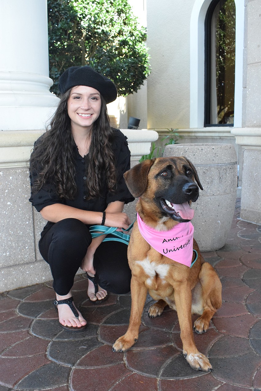 Morgan Tinl, the lead shelter specialist for the Humane Society at Lakewood Ranch, welcomes guests with Beckett, a shepherd hound mix.