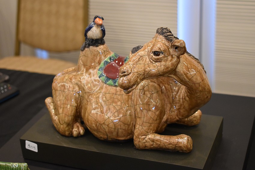A camel sculpture by Susan Kerr demonstrates her Raku technique that infuses smoke into the surface of a sculpture to generate cracks.