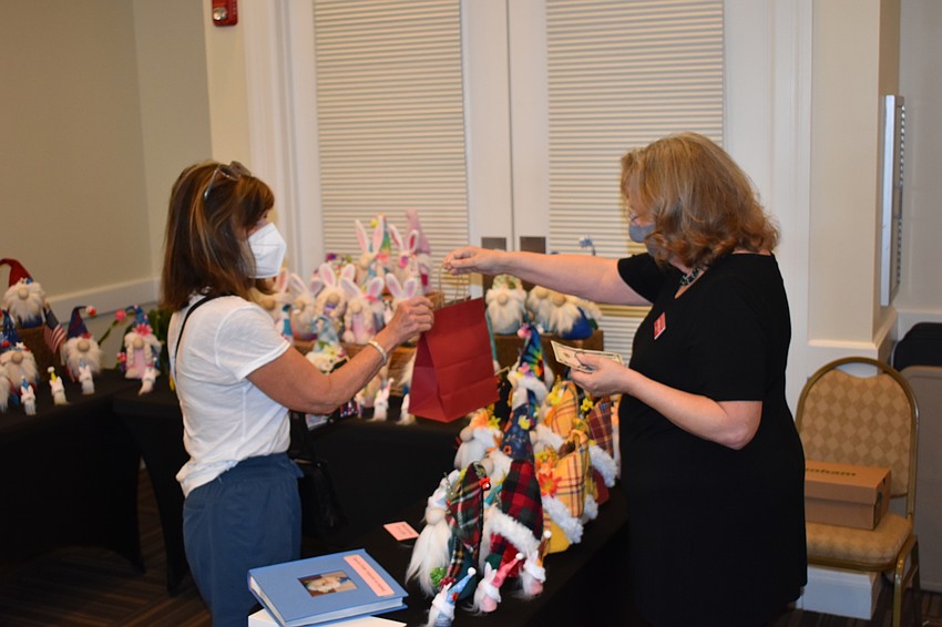 Lakewood Ranch resident Debbie Bergtholdt purchases a gnome from Linda McMillan.