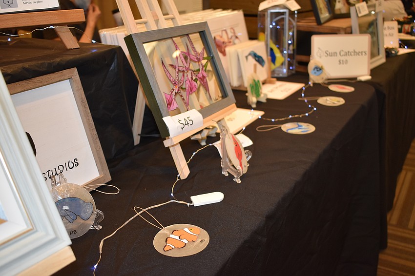 A close view of Arline Bremer's glass paintings reveals their reversal of paint layering, and the bright colors that result from the glass surface.