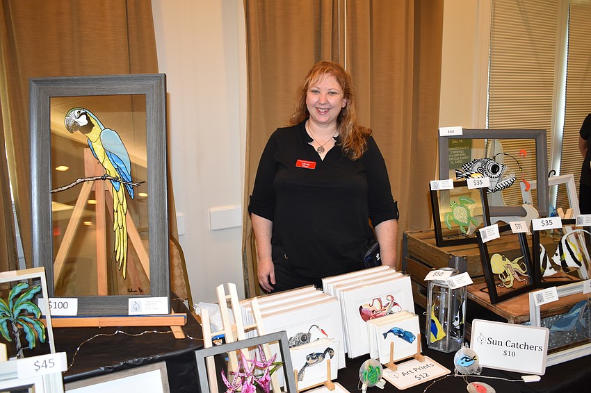Arline Bremer's table features reverse paintings on glass; this medium offers reversed layering of paints and more vibrant colors, due to the glass surface.
