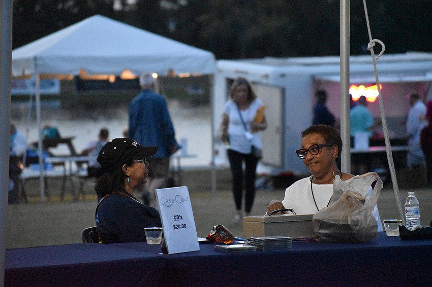 Sarasota's Pam Greer and Sherelle Matthews manage the entry table and enjoy jazz at the same time.