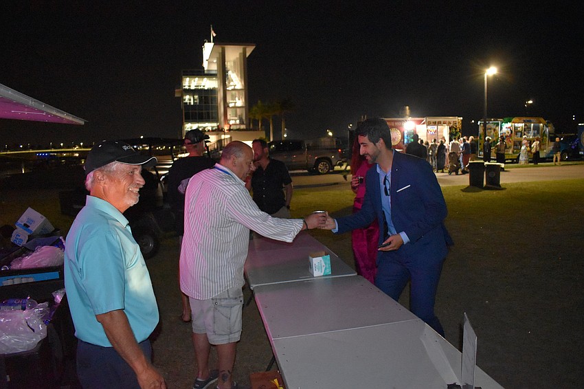 Sarasota resident Angelo Ragone of the SRQ Club greets Alejandro Arenas of La Lucha.