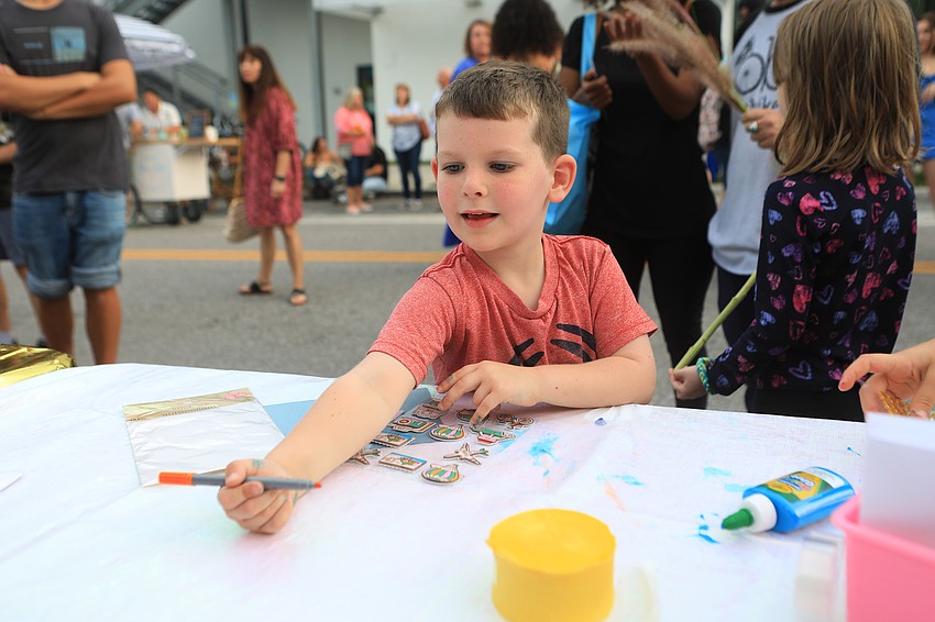 Sylas Cox gathers art supplies.