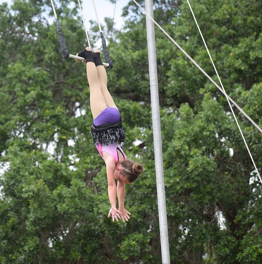 Harley Johnson, 7, of Myakka City, thrilled the crowd by hanging from the trapeze by her feet.
