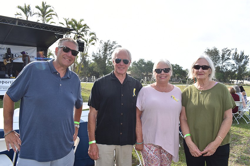 David Brownstein, John Grimes, Barbara Grimes and Jean Raymond took a break from setting up their table.