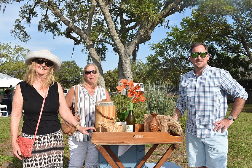 Sarah Whisnant, Barbara Higgins and Jordan Chancey stand by their own bar cart.