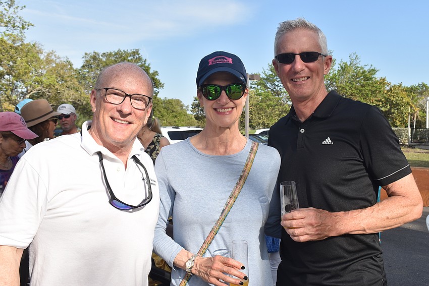 Randall Graham, Paula Kramer and Mark Kramer stood in the shade of the Michael Saunders and Company tent.