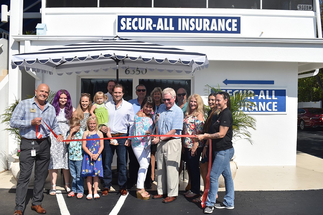 Ambassadors Darrin Caldwell and Kellie Spring cut the ribbon along with Sandra Smith, the Secur-All team and the Reed Medical Group team.