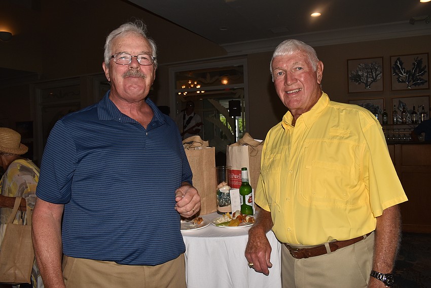 Bill Ferry and Bill Allen took a break to snack on the available food.