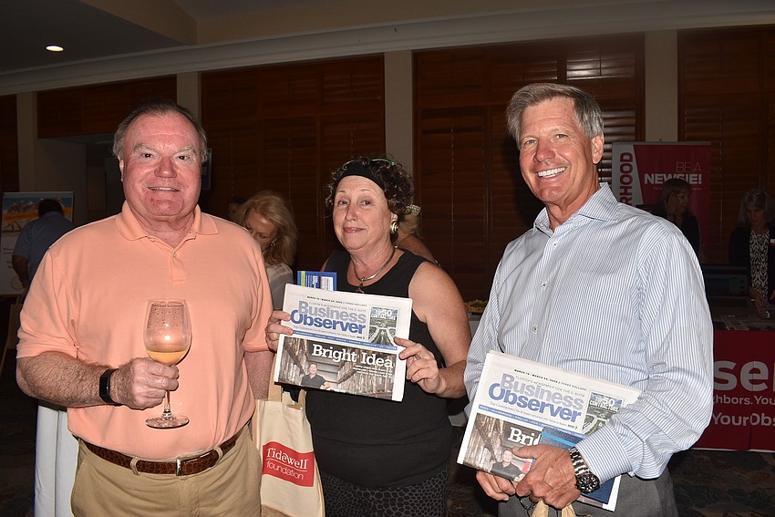 Russ Callahan, Linn Torres and Philip Deming picked up copies of the paper.