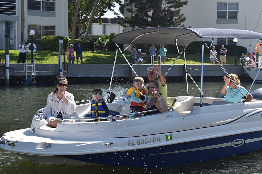 Logan and Kaiden Lynch blow bubbles on Patty and Tom Guido's boat.