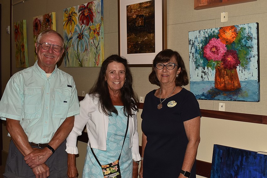 Scot and Nancy Diedrich with artist Pat Lundy, whom they met recently.