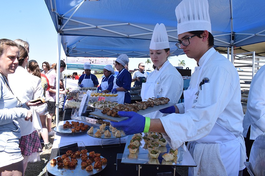 Manatee Technical College culinary students Erica Kennedy and Nicholas Klauber serve delights to My Hometown Fest attendees.