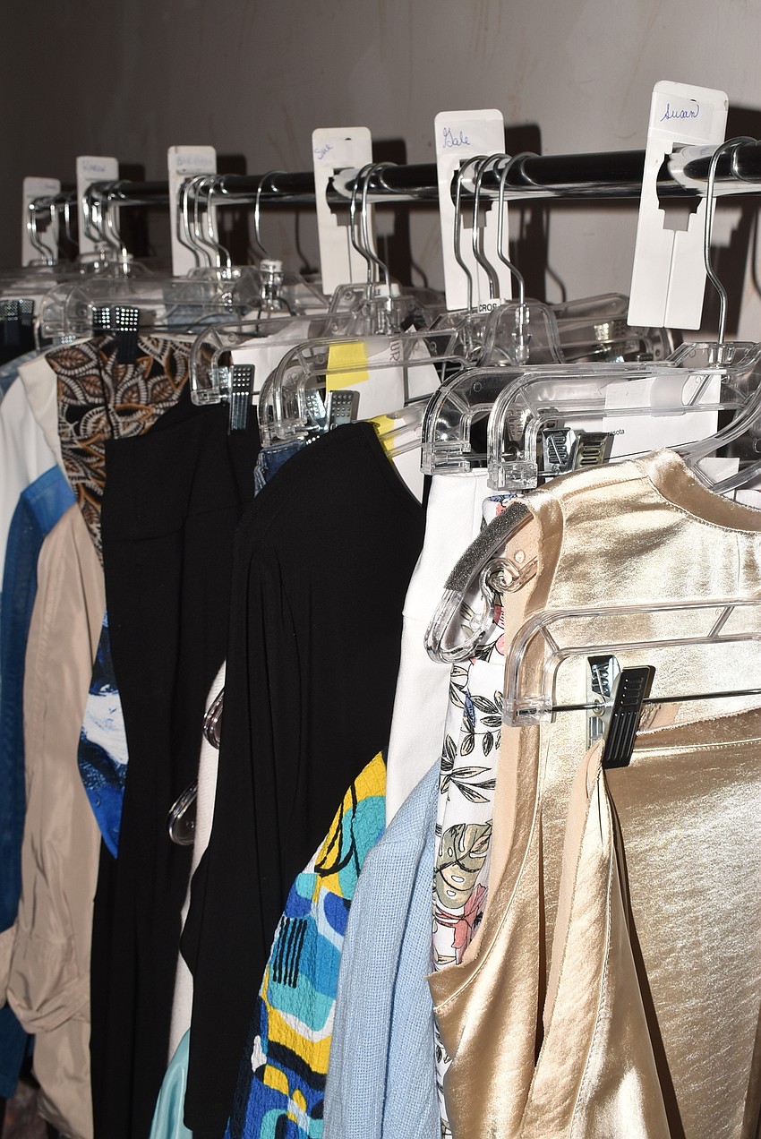 Outfits awaited their models in the dressing room.