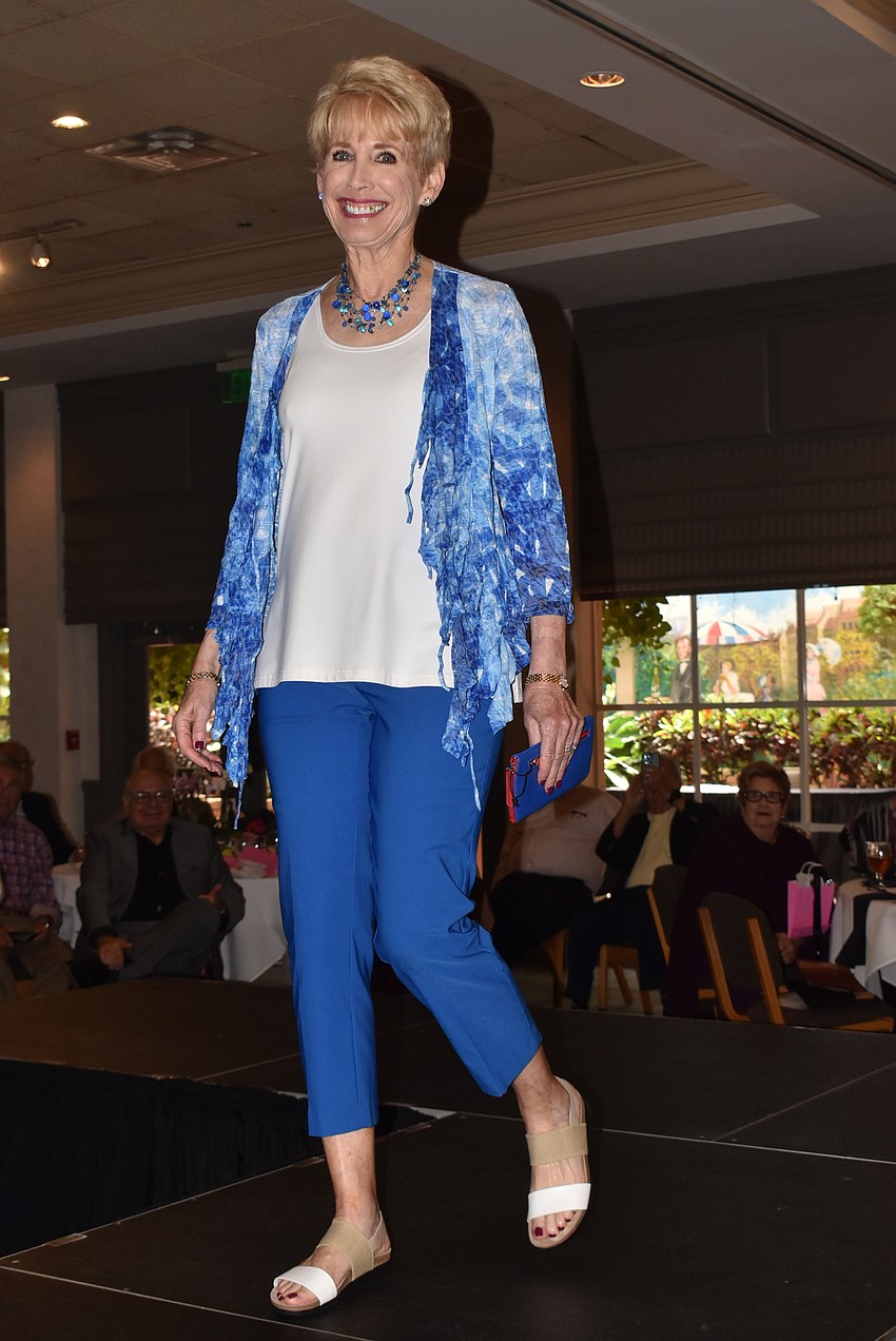 Bonnie Wilder walks the runway in a blue outfit.