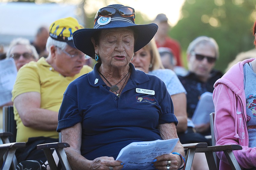 Brenda Johnston sings along in support.