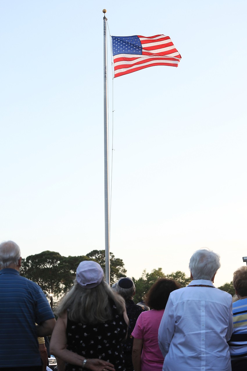 Attendees pledge allegiance near the end of the event.