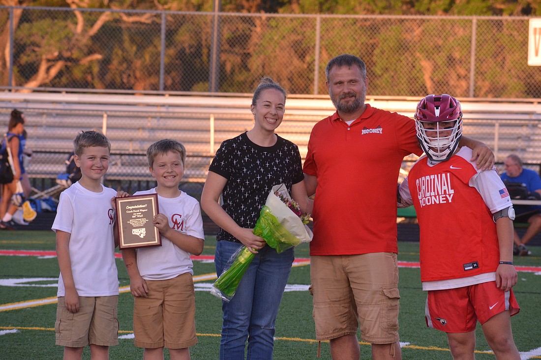 Derek Wagner, standing second from right, was honored before Cardinal Mooney&#39;s game against Canterbury. Wagner poses alongside his family (Bryce Wagner, Grant Wagner and Sara Wagner) and Mooney senior Joseph Beach.