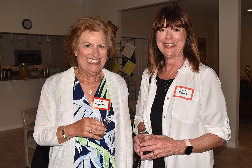 Carole Sugarman and Joan Petros caught up in the clubhouse.