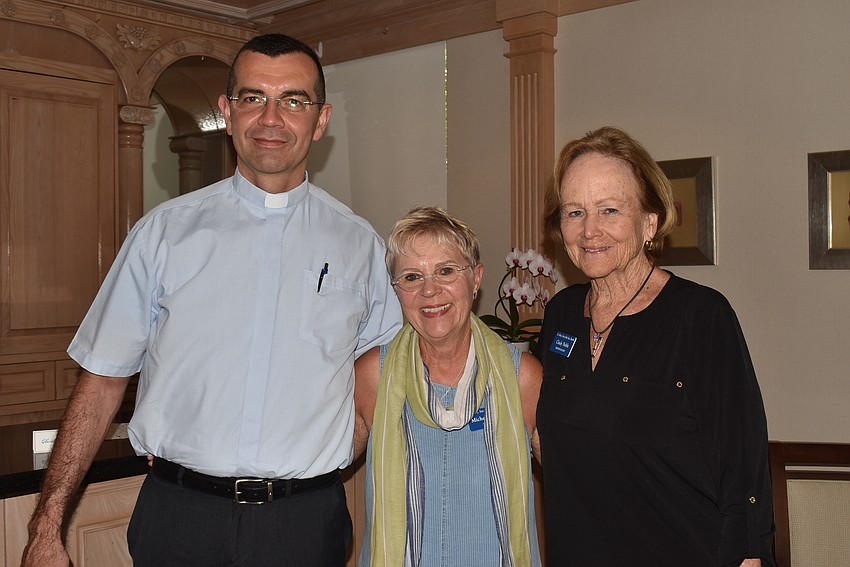 Rev. Robert Dziedziak, Mickey Abbey and president Cindy Noble chatted after lunch.