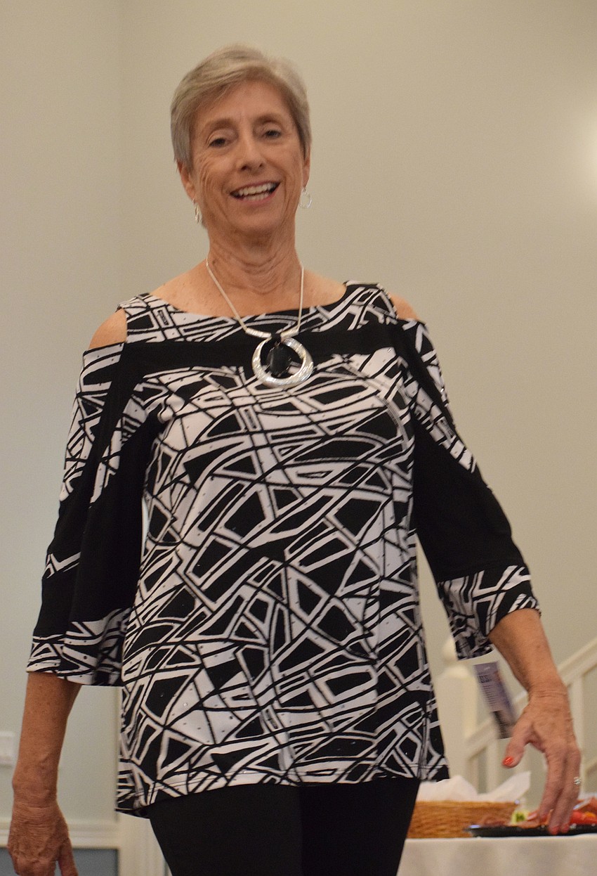 Cascades' Susan Braunstein smiles as she goes down the runway.