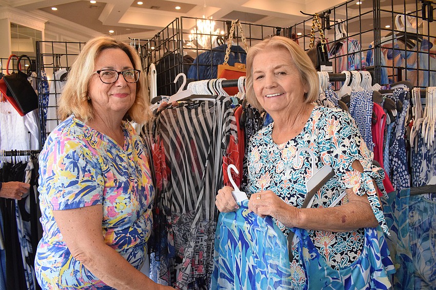 Cascades' Paula Terrenzi and Sandy Collins search for the perfect outfit during the fashion show's sale.