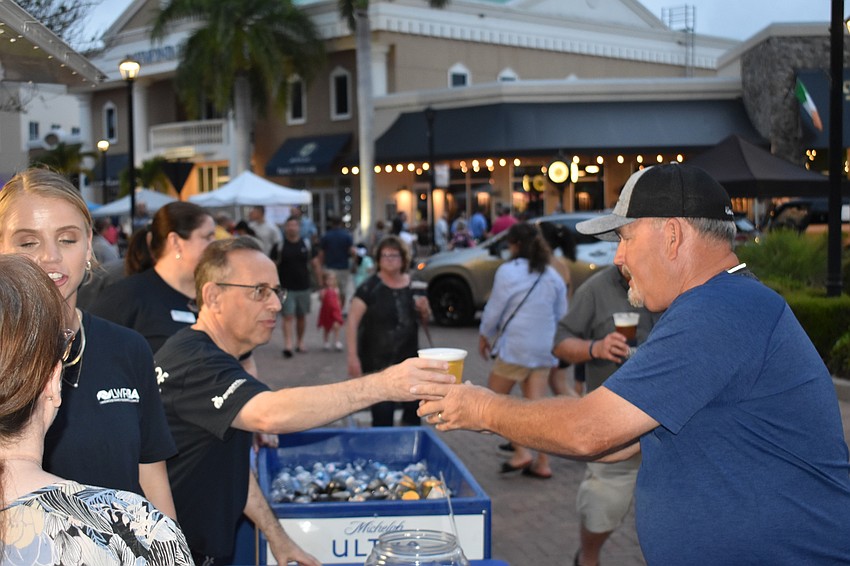 Lakewood National's Brad McKeehan buys a beer from David Grace, who was volunteering with the Lakewood Ranch Business Alliance.