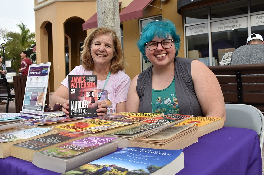 Molly Saunders and Chris Culp give away free books during Music on Main.