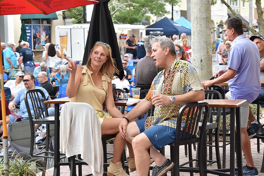Friends Jeri Fitchette of Lakewood National and Rick Romano of Greenbrook find a comfortable spot to listen to Kettle of Fish.