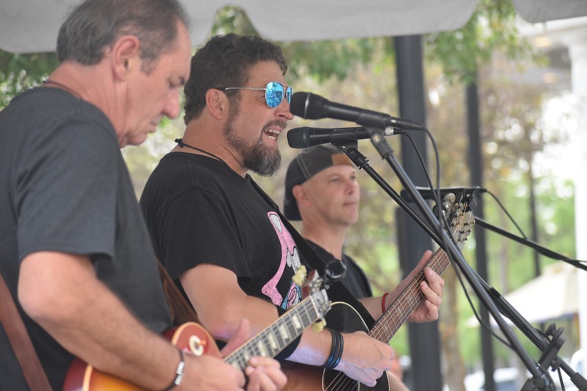 Kettle of Fish's Greg Polous on electric guitar, Dana Lawrence on acoustic guitar, and Todd Adams on keys, entertain the Music on Main crowd.
