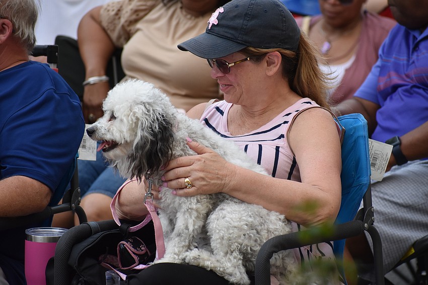Lakewood Ranch resident Becky Wilkes and her dog Molly watch the performance.