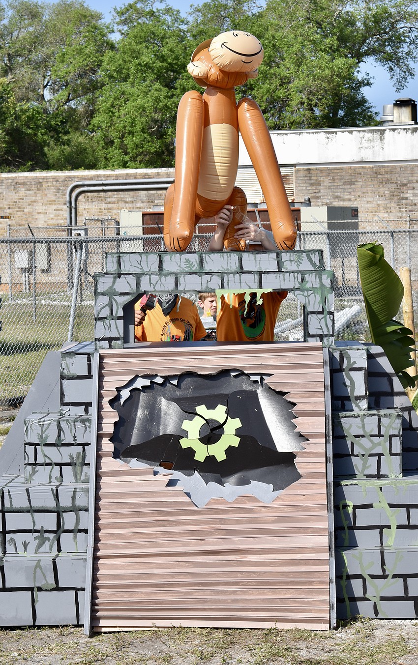 An inflatable monkey stands watch over a track obstacle.