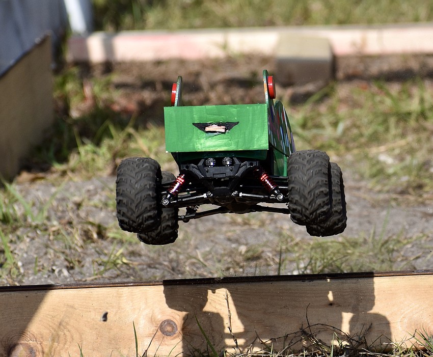 One of the race cars takes flight over a ramp on the elementary and middle school track.