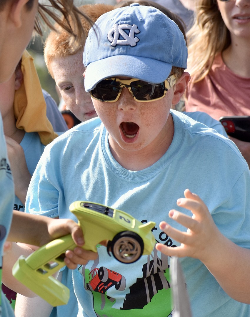 Jonathan Keisacker reacts to his team's race car on the track.